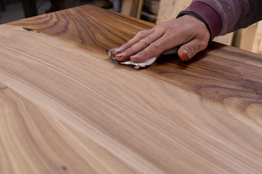 A table with different types of wood finish being applied